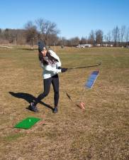 Carley Bresney completes a shot in the Chili Open Golf Classic on Saturday, Feb. 3 at the Sussex County Fairgrounds. (Photos by Nancy Madacsi)