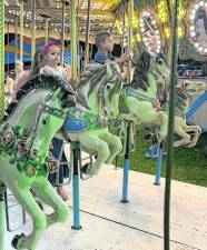 <b>Children ride the carousel.</b>