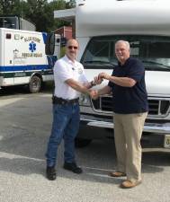 SCARC Director of Facilities, Transportation and Risk Management Tony Barile hands the keys of the minibus to Blue Ridge Captain Craig Fary.