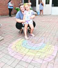Megan and Abigail Guarducci of Ogdensburg pose next to a picture of a rainbow.