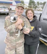 Frank Cutrone is greeted by his mom, Mary, and dog, Chi Chi, upon his return to Fort Drum (Photo provided)