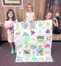 Girl Scouts from Troop 98765 in Ogdensburg pose with the quilt created by 7 different troops in the Wallkill Valley area.