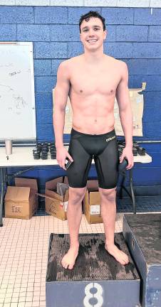 Danny Westervelt stands on the eighth-place podium after the 100-yard freestyle.