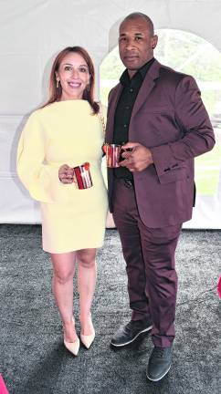 A lady in a yellow dress with a man in a suit are: Toni Dingmann of Warwick, N.Y., and Anthony Hawthorne of Vernon pose for a photo.