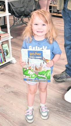 Piper Griffin of Ogdensburg holds a Harry Potter book.