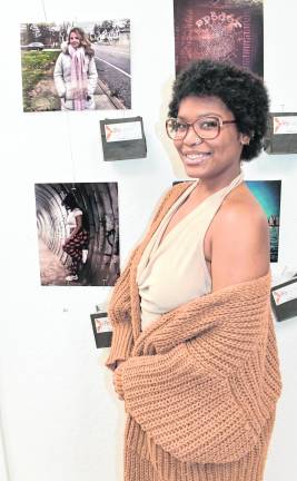 Mikayla Cherry of East Orange stands near her photo, Moving Forward.