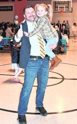 Jim Thonus holds his daughter, Lyla.