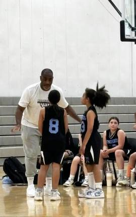Cornell Thomas talking to some of his many athletes he coaches through his clinics, clubs, tournament and camp basketball programs. He is also a highly acclaimed international motivational speaker.