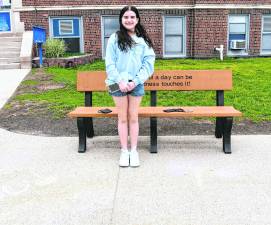 Olivia Verpent of Franklin stands by a chalk drawing.