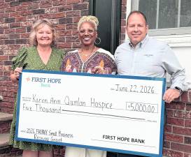 <b>Karen Ann Quinlan Hospice executive director Lee Ellison, center, accepts a check donation from First Hope Bank Senior Vice President Deena Smith and President/Chief Executive Officer/Chairman of the Board Daniel Beatty.</b>