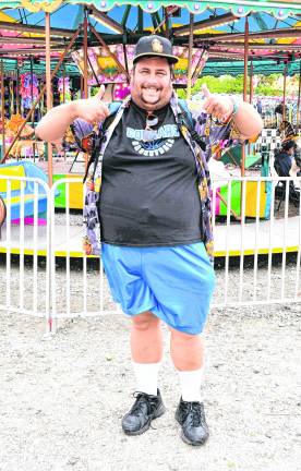 <b>Brandon Bordt of Lafayette stands in front of the carousel.</b>