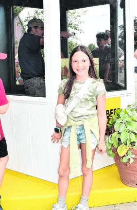<b>Eily Wagner of Frankford poses in front of the bee demonstration.</b>
