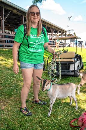 <b>Katie Swisshelmie with Spicy Dorito at the Goat Story Hour run by the 4-H Heart and Hooves Goat Club on Saturday, Aug. 2. (Photo by Nancy Madacsi)</b>.