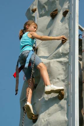 Isabelle Stecher, 10, of Franklin easily handled the crux move on the climbing wall before being lowered back to the ground.