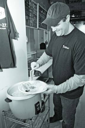 Photo by Chris Wyman Chad Weiber puts together a platter at the new Vernon location of Taco Hombre.