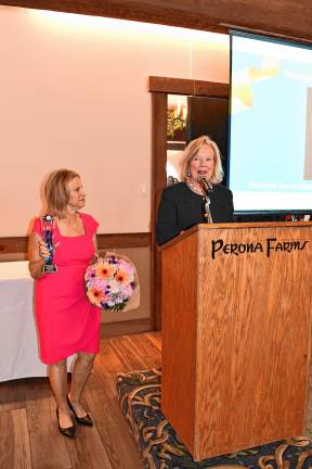 WO1 Tammie Horsfield, left, president of the Sussex County Chamber of Commerce, holds the Woman of the Year award for Deborah Berry-Toon, executive director of Project Self-Sufficiency. (Photos by Maria Kovic)