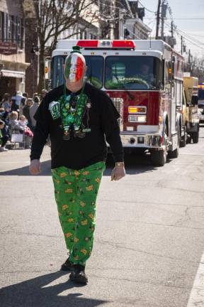 Bob Russell, marching with the Hamburg Fire Department, gets into the spirit of the day with his face painted the colors of the Irish flag.