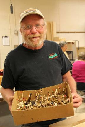Mike Shatt creates small bird carvings.