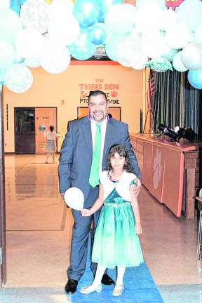 Harold and Samara Olarte are shown under the arch.