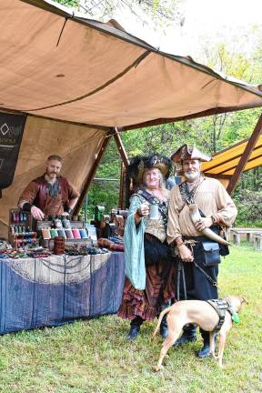 Eva and William Whorley of upstate New York with their dog, Taz At left is Colin Maythenwi of Ritual Ops Leatherworks.