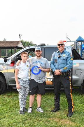 Conner Trossman and Bill Gusta of Vernon pose with Hardyston police Sgt. Alan Carbery.