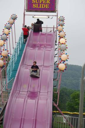 A youngster slides down the Super Slide.