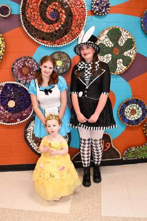 Emma Heddy of Franklin poses with characters from Alice in Wonderland