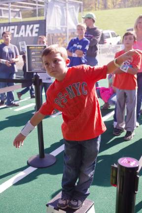 Michael Pecoraro, 7, of Vernon tries his hand at an agility motion simulator. His body's movements controlled a video image of a football player making his way down the field.