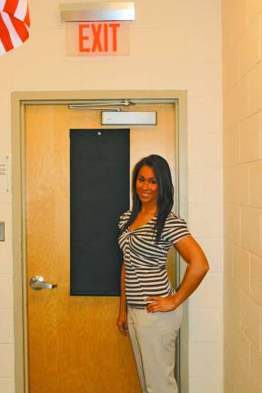 Co-owner Christine M. Bacolas showing the Hideaway Helper on a classroom door