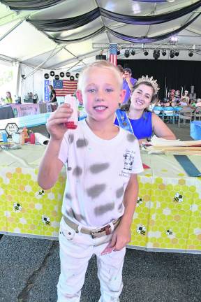 <b>Eli Bast of Green Township shows off a candle he made.</b>