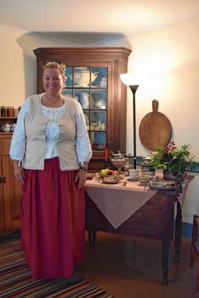 <b>Museum curator Ashley Ziccardi tells visitors about the keeping room.</b>