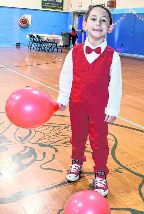 Mason Heddy holds a balloon.