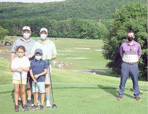 The Haughs family: Dad Brett, Grand Dad Larry. James social distance in their masks from event coordinator Ryan Delaney at the 2020 Sussex County Long Drive qualifier (Dr. John T. Whiting)