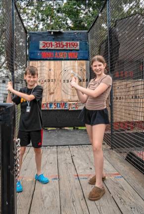 <b>Dillon and Charlotte Boehm try ax throwing Tuesday, Aug. 5. (Photo by Nancy Madacsi)</b>