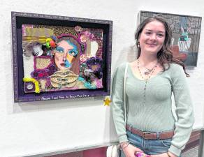 Ashley Caraccio is shown with her scholarship-winning piece.