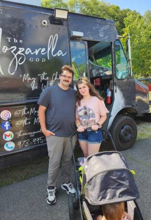 Amanda, Jesse and Stella Delgrosso pose in front of the Mozzarella God food truck.