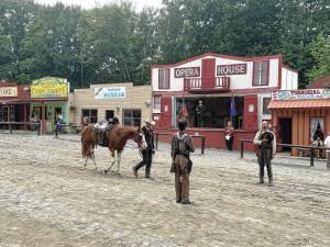Cowboy Gabe Wellington walks Ranger into town during an empty saddle ceremony honoring the late Robert ‘Pony Bob’ Erven on Saturday, July 26 at Wild West City in Byram. (Photo by Aidan Mastandrea)
