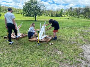 ST1 Hardyston Middle School competitors and high school assistants, from left, Noah DeRenzo, Emily Guarino and Jovanni Portilla prepare their launcher for final testing during the annual STEM League Challenge on May 7. (Photos by Juleanna Green)