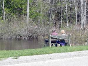 A couple enjoys the quiet and solitude brookside at Wawayanda State Park.