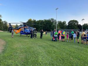 FN1 At the National Night Out event in Franklin, residents line up for a look inside an Atlantic Health System helicopter, which is used for emergencies and transporting critical patients. (Photos by Daniele Sciuto)