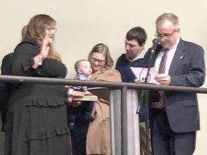 Sussex County Commissioner Jill Space takes the oath of office for a full three-year term at the annual reorganization meeting Jan. 4 at Sussex County Community College. State Assemblyman Hal Wirths, right, administered the oath to her. (Photos by Kathy Shwiff)