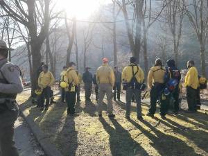 Wildland firefighters gather at Kittatinny Point for a morning briefing before heading up Mount Tammany.