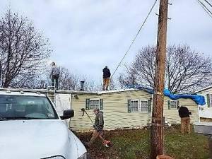 Volunteers from Fairview Lake YMCA help repair the roof. (Photos provided by Liz Pattermann)