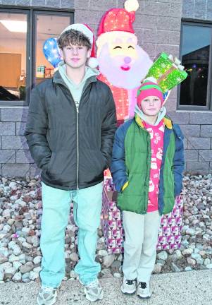 Michael and Christian Walters of Franklin are shown in front of a light-up Santa Claus.