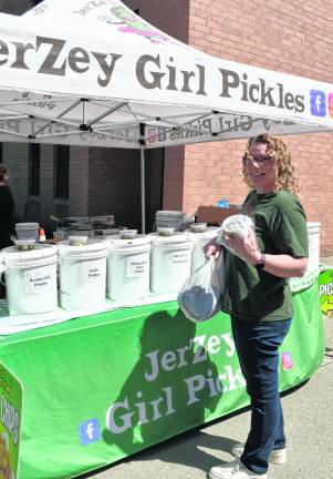 Kathy Malure of Hamburg stands in front of a Jerzey Girl PIckles table.