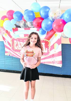 Brynlee Greco holds a Circus sign.