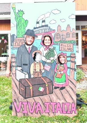 Sal and Lori Tardito of Brooklyn pose behind a board with Ave Colby of Oakland.