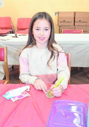 Arabella Fox of Jefferson looks up from her art project.