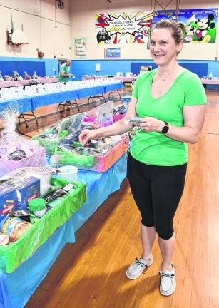 Christy Kota of Hardyston places a ticket in a bucket to bid on an item. Over $13,000 worth of tickets have been sold.