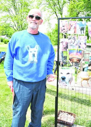 Jerry Nicholson points at a picture of his dog, Hendricks.